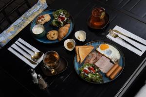 a table with two plates of breakfast food on it at Beanstalk Bangkok in Bangkok