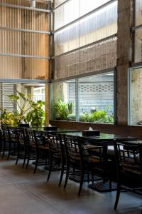 a row of tables and chairs in a restaurant at Beanstalk Bangkok in Bangkok