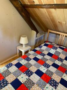 a bedroom with a checkered quilt on a bed at Farmhouse near beach in Kloosterzande