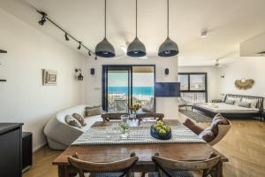 a living room with a table and a couch at Serene Studio Apt w Balcony Overlooking the Sea by Sea N' Rent in Tel Aviv