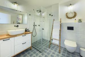 a bathroom with a sink toilet and a shower at Serene Studio Apt w Balcony Overlooking the Sea by Sea N' Rent in Tel Aviv