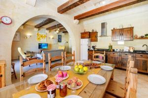 a kitchen and dining room with a table with food on it at Narcisa Holiday Home in Nadur