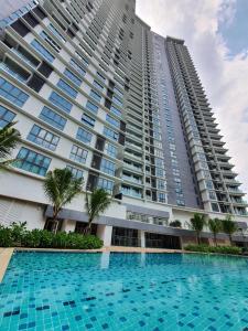 a large building with a large swimming pool in front of it at Mont Kiara 163 Mall (The Ooak) Private Room in Kuala Lumpur