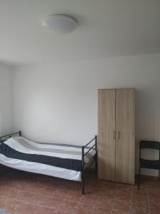a bedroom with a bunk bed and a cabinet at Chalupa V Meruňkovém Sadu in Šakvice