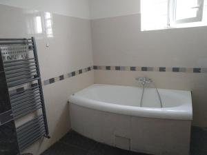 a white bath tub in a bathroom with a window at Chalupa V Meruňkovém Sadu in Šakvice