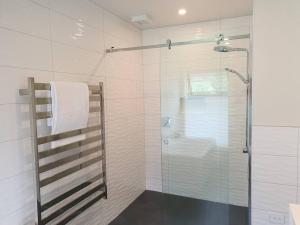 a bathroom with a shower with a glass door at Beautiful Lake and Alpine Views - Queenstown in Queenstown