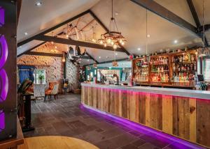 a bar with a wooden counter and a barraged at Noble Court Holiday Park in Narberth