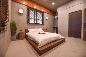 a bedroom with a large bed in a room at Eryang Homestay in Tainan