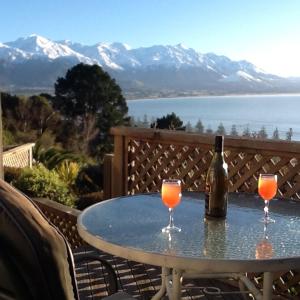 a table with two glasses and a bottle of wine at Absolutely in Kaikoura
