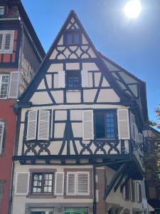 a half timbered building with white and black at Appartement de la noblesse - designed by C.M in Sélestat