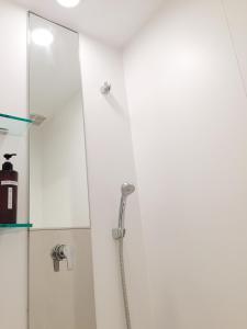 een douche in een badkamer met een glazen deur bij Guesthouse Channel-Kan in Kamojima