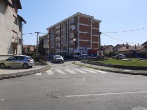 a street with cars parked in a parking lot at Apartman Maja in Bijeljina