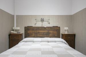 a bedroom with a large bed and two night stands at Loggia Fiorentina in Florence