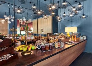 a restaurant with a buffet with food on a counter at June Six Hotel Berlin City West in Berlin