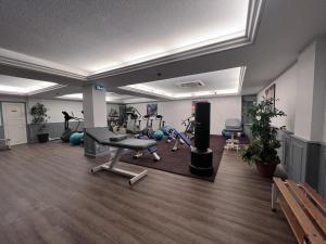 a gym with exercise equipment and a bench in a room at Logis Hôtel Spa la Poste in Vitry-le-François
