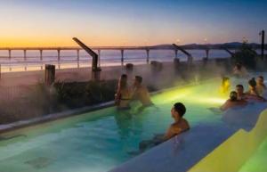 a group of people swimming in a hot tub at A Little Bit Beachy Modern Guest Room and Private Toilet in Christchurch