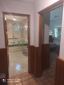 een badkamer met een douche en een glazen deur bij Villa Radunia in Borzestowska Huta