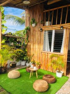 a garden with a table and stools on green grass at Joyful Hut with Netflix and Perfect Sunrise View Maya, Daanbantayan 