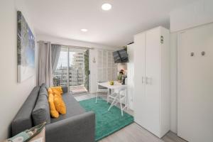 a living room with a gray couch and a table at Funchal Sea View I by An Island Apart in Funchal +13 photos