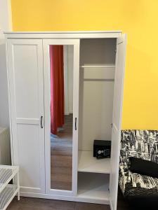 a white cabinet with a door in a room at Casa Armeana Studios in Iaşi