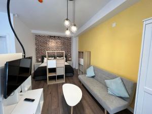 a living room with a couch and a television at Casa Armeana Studios in Iaşi