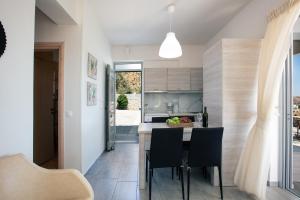 a kitchen and dining room with a table and chairs at Evgoro Luxury Suites in Agia Galini