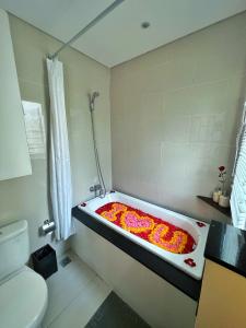 a bath tub filled with flowers in a bathroom at The Sakaye Villas & Spa in Legian