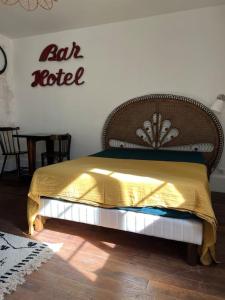 a bedroom with a bed with a yellow blanket on it at Moulins centre : Appartement N*6 in Moulins
