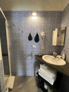 a bathroom with a sink and a shower at La Casa di Litz in Naples