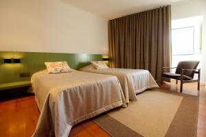 Cama ou camas em um quarto em Hotel Casa da Nora