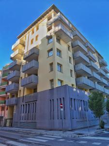 a tall apartment building on the corner of a street at Acquario sulla laguna EXCLUSIVE Luxury Apartment in Grado