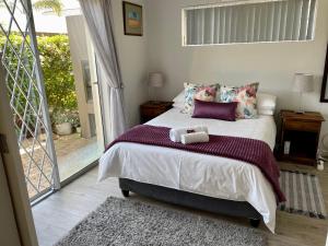 a bedroom with a bed with two towels on it at D'urban Ridge Self catering Apartment in Cape Town