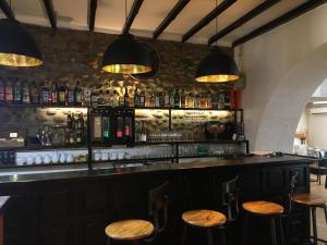 a bar with wooden stools in a room at Logis Hôtel de France & Restaurant Pamiers in Pamiers