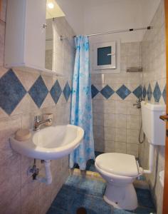 a bathroom with a sink and a toilet at Thea Studios in Kalamakia