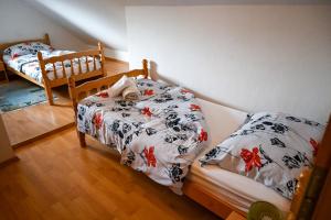 a bedroom with two twin beds with floral sheets at Apartment Maca Bled in Bled