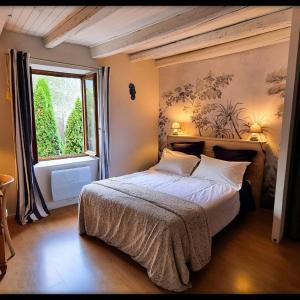 a bedroom with a large bed and a window at Baleine-Les Jardins de Kuz in Bernin