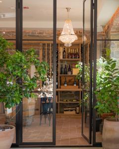 a tasting room with glass doors and potted plants at Villa Majda in Osp