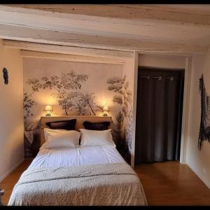 a bedroom with a large bed with two pillows at Baleine-Les Jardins de Kuz in Bernin