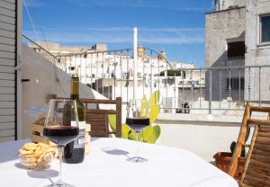 - une table avec deux verres de vin et un panier de pain dans l'établissement Casa Zefiro - The Fab Stay, à Ostuni 10 autres photos