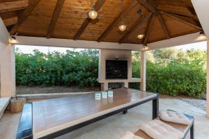 a patio with a table and chairs and a television at "Mare et Sol" apartments in Sveti Filip i Jakov