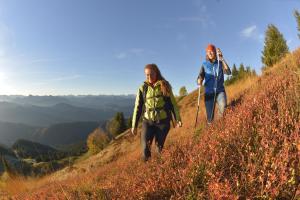 two women are walking up a hill at Wohnung Hochalm in Lenggries