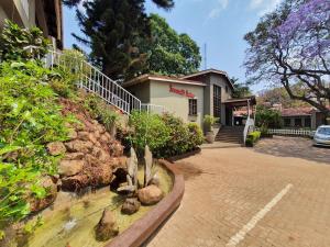 a house with a garden in front of it at Serendib Suites and Conference Center in Blantyre