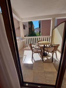 a view of a balcony with a table and chairs at VILA MAKA in Budva