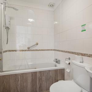 a bathroom with a tub and a toilet and a sink at The Castle Of Brecon Hotel, Brecon, Powys in Brecon