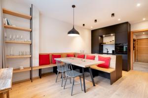 a kitchen and dining room with a table and chairs at Garten Suite Kirchberg by Alpine Host Helpers in Kirchberg in Tirol