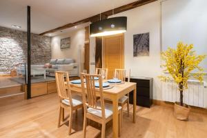a dining room and living room with a table and chairs at Smart Urban by People Rentals in Donostia-San Sebastián +29 photos