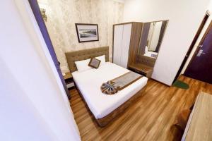 Postel nebo postele na pokoji v ubytování Wisteria Hotel