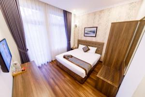 Postel nebo postele na pokoji v ubytování Wisteria Hotel
