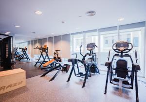 a gym with several exercise bikes in a room at Nasma Luxury Stays - Serene Apartment With Balcony Steps From The Sea in Abu Dhabi