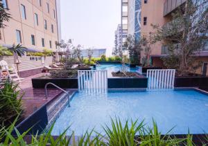 a swimming pool in the middle of a building at Nasma Luxury Stays - Serene Apartment With Balcony Steps From The Sea in Abu Dhabi